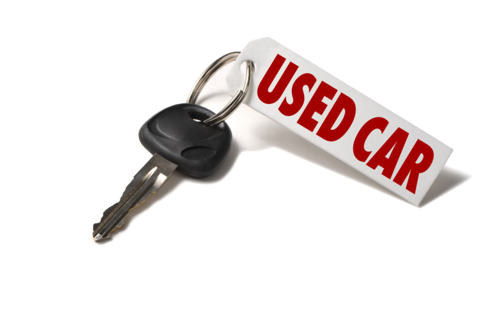 Car key with a used car tag on it