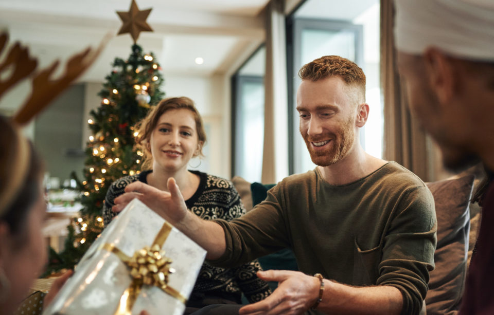 Shot of young friends opening their Christmas gifts