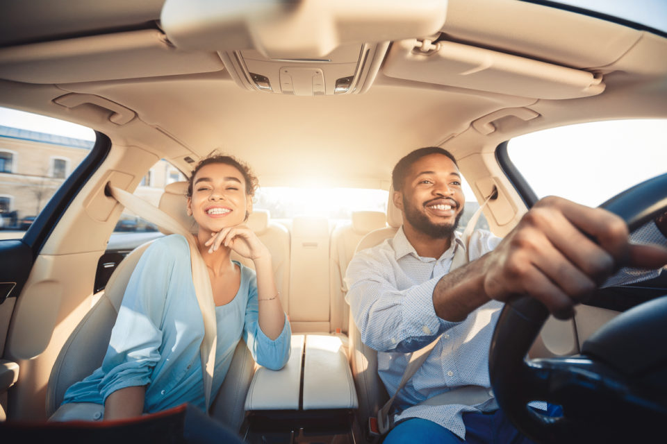 excited couple enjoying drive