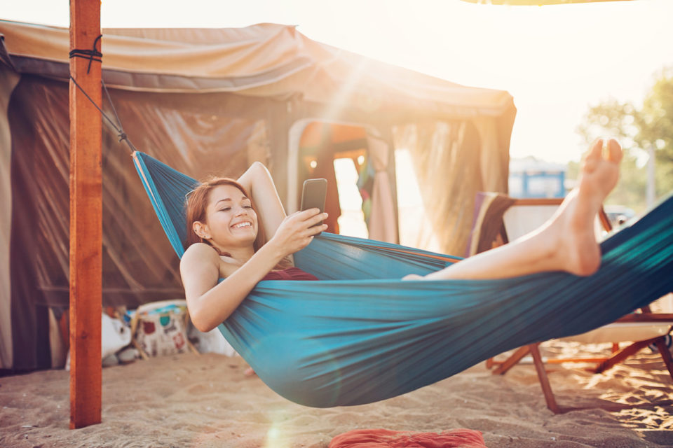 Woman camping, laying in a hammock