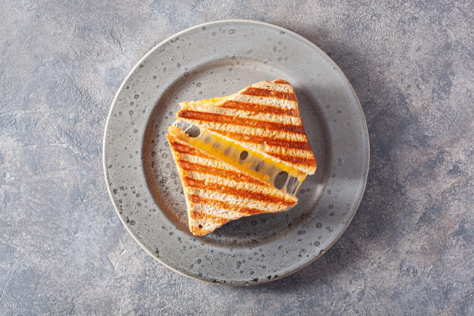 grilled cheese sandwich on gray concrete background