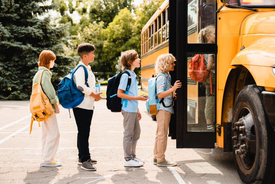 kids getting on the bus