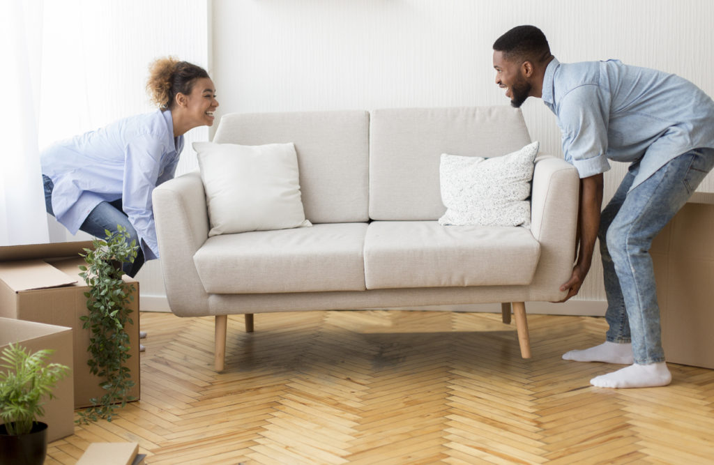 Couple moving a couch together