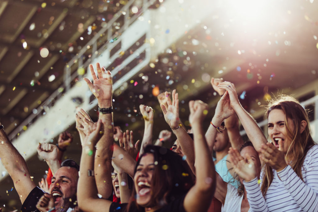 Football fans celebrating a victory in stadium