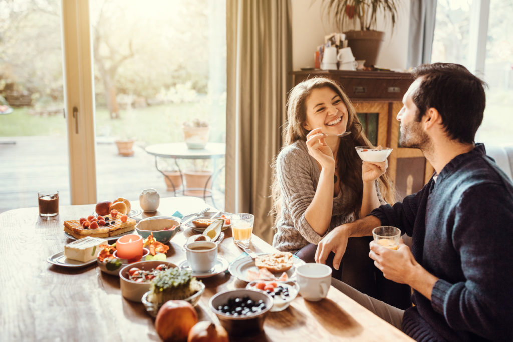 happy couple enjoying breakfast together